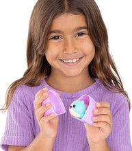 Load image into Gallery viewer, Girl holding Aphmau Mystery MeeMeows Squishy Figure in a purple container.