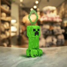 Load image into Gallery viewer, Minecraft 5 Inch Creeper bag hanger plush with pixelated detailing, soft and huggable design, equipped with a clip.