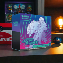 Load image into Gallery viewer, Pokemon TCG Journey Together Elite Trainer Box on table, surrounded by gaming decor.
