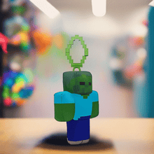 Load image into Gallery viewer, Minecraft 5 Inch Zombie Bag Hanger Plush with pixelated design on display.