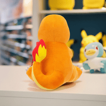 Load image into Gallery viewer, Pokemon 8 Inch Plush - Charmander Sitting on a display shelf.