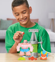 Load image into Gallery viewer, Heroes of Goo Jit Zu Hero Creator Blazagon kit with child assembling custom figure.