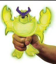 Load image into Gallery viewer, Goo Jit Zu Glow Shifters Scorpius toy being squished, glowing green in dark.