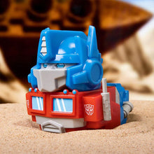 Load image into Gallery viewer, TUBBZ Transformers Optimus Prime Collectible Duck with blue and red color scheme on sand background.

